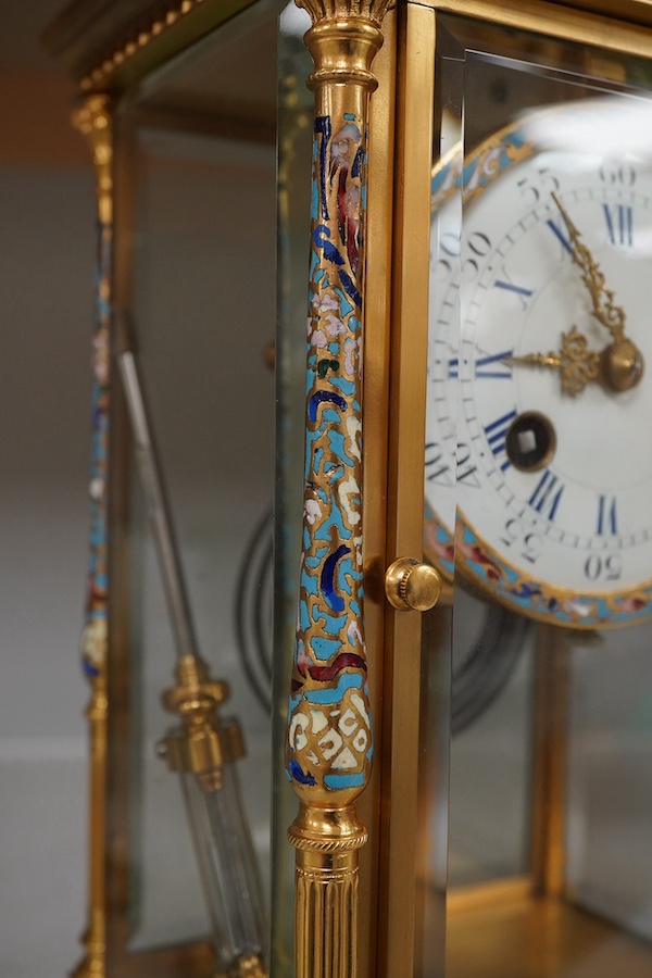 A late 19th century French ormolu and champlevé enamel four glass mantel clock, with mercury filled pendulum, retailed by Maple and co Ltd, Paris, 27.5 cm high. Condition - good